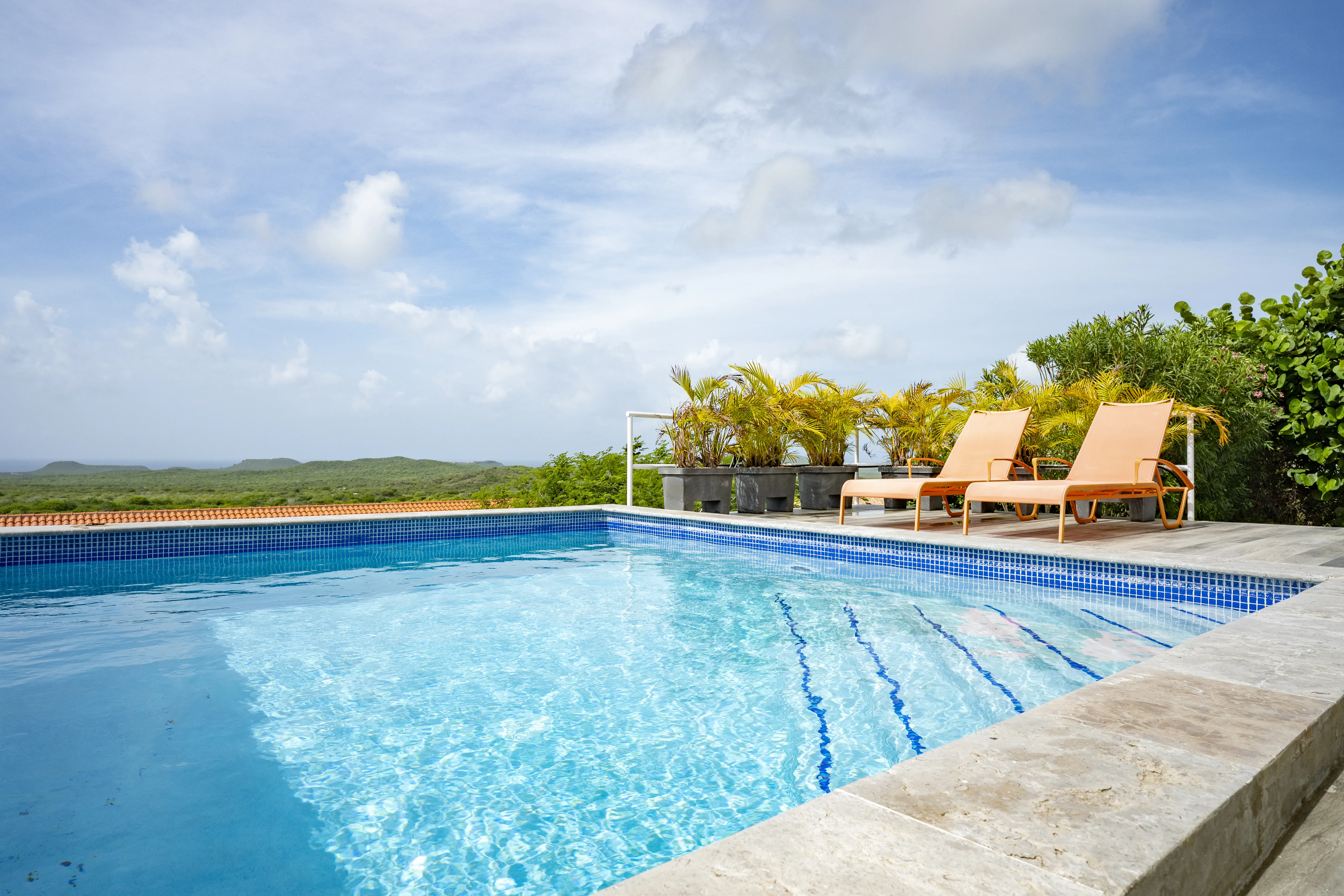 Swimming pool with sun loungers and views across Curaçao
